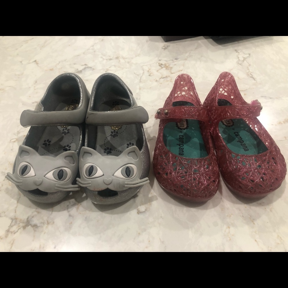 2 pairs of mini Melissa shoes.